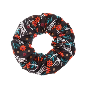 Halloween scrunchie with white skull hand and red flower patterns on black fabric