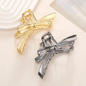 Elegantes pinzas para el cabello en metal dorado y negro metalizado con diseño de lazo chic