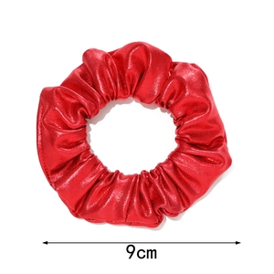 Close-up of metallic red mermaid scrunchie showing fabric texture and 9cm diameter size