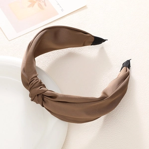 Classic mocha brown twisted wide headband with French retro style in a studio setting