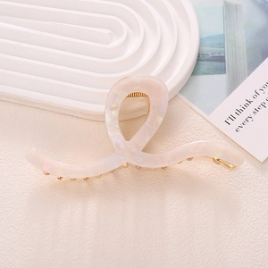 Elegant pearlescent pink acetate shark hair claw clip with golden metal spring for women