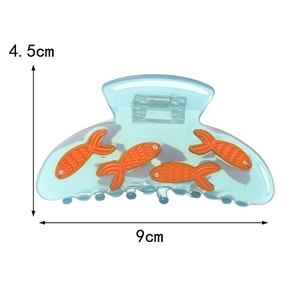 Blue acetate hair claw clip with orange goldfish pattern and size marks 9cm by 4.5cm