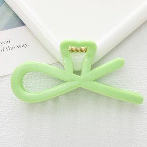 Minimalist light green bow-shaped hair claw clip with gold metal spring for women