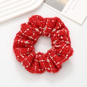 Elegant red tweed scrunchie hair tie with thick woven texture for stylish buns