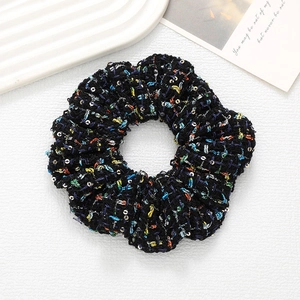 Elegant black tweed scrunchie with glitter sequins for stylish bun hairstyles
