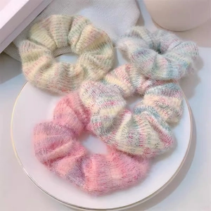 Sweet mohair knit hair scrunchies in pastel gradient colors on a white plate