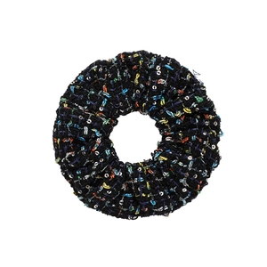 Detail of black thick fabric hair scrunchie with colorful stitching and silver sequins
