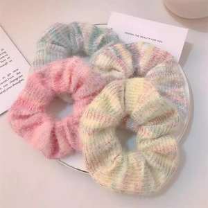 Set of 4 gradient mohair knit scrunchies in pastel colors on a ceramic tray