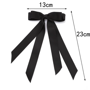 Detail of black satin bow hair clip with long ribbons, 13cm width and 23cm length