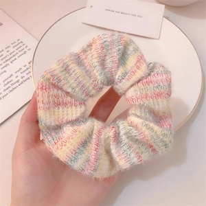 Detailed macro view of a colorful mohair knit plaid scrunchie with soft fluffy texture