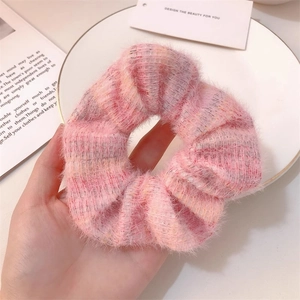 Detailed close-up of pink mohair knit scrunchie with soft fuzzy texture and plaid pattern