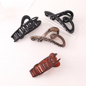 Matte irregular heart hair claw clip set in various colors on wooden surface