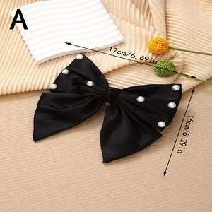 Detail showing dimensions of 17x16cm for the black satin bow hair clip with pearls
