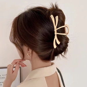 Pince à cheveux élégante en métal doré en forme de nœud pour femmes
