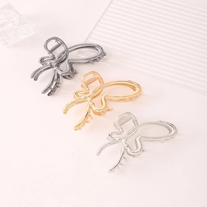 Detail view of elegant butterfly hair claws in gold, silver, and gunmetal finishes
