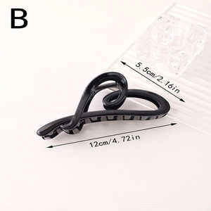 Detail view of large black heart-shaped hair claw clip with dimensions 12cm by 5.5cm