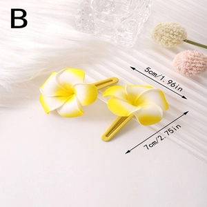 Detail view of tropical plumeria hair clips with size markings of 5cm and 7cm