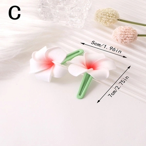 Detailed view of plumeria hair clips with pink gradient petals and size dimensions