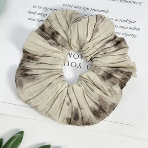 Macro detail of French vintage scrunchie featuring ink flower pattern and pleated texture