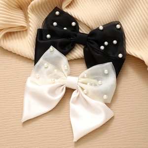Elegant satin and organza bow hair clips with pearls in black and creamy white colors