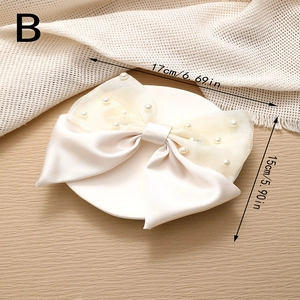 Detail view of large cream satin bow hair clip with pearls and sizing annotations