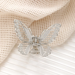 Elegant hollow butterfly hair claw clip in silver alloy with detailed textured finish