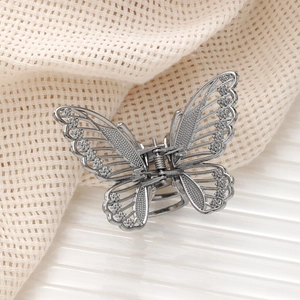 Exquisite silver butterfly hair claw clip with hollow wings and sparkling rhinestones