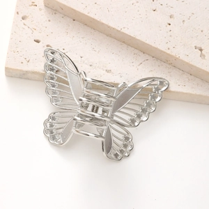 Polished silver metal hair claw clip featuring a delicate hollow butterfly wing design