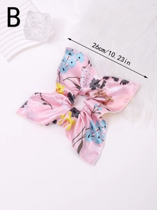 Close-up of pink floral print satin scrunchie showing 26cm size and soft texture