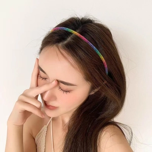 Elegant thin metal headband with colorful gradient rhinestones shown on a model