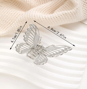 Detail view of silver hollow butterfly hair claw clip with dimensions 6.8cm and 4.7cm