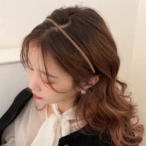 Close-up of thin champagne crystal headband with sparkling rhinestones on model