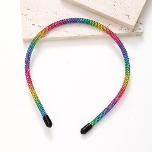 Macro detail of the sparkling rainbow rhinestone headband with protective black rubber tips