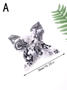 Detail showing white paisley print scrunchie with long tail and 26cm length measure