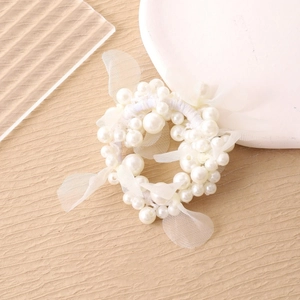 Elegant pearl hair scrunchie with white mesh bow decoration on light background