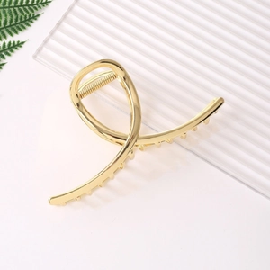 Minimalist gold metal hair claw clip with twisted line design for elegant women styling