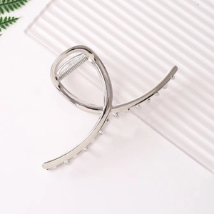 Elegant minimalist silver metal hair claw clip with twisted design for women