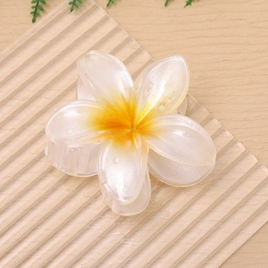 Pearlescent plumeria flower hair claw clip with yellow gradient for elegant hair styling