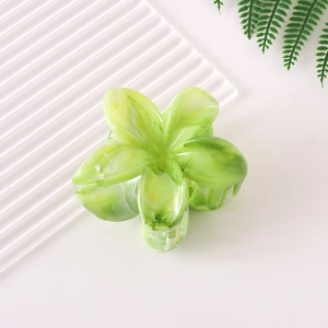 Detail view of the green gradient plumeria hair claw clip with a marble acetate finish