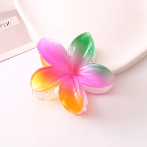 Detail view of the gradient plumeria hair claw clip made of translucent resin