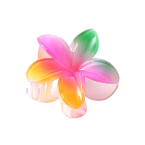 Detail view of the gradient plumeria hair claw clip with a glossy translucent finish