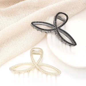 Elegant rhinestone hollow hair claw clips in black and gold finish with pearls