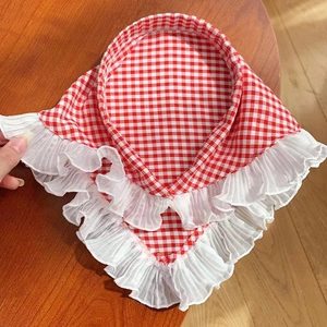 Detail of red gingham triangle bandana featuring double-layered white pleated lace trim