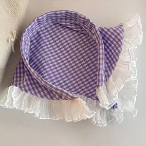 Detail of purple plaid headscarf with ruffled white lace trim and textile texture