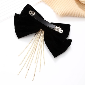 Elegant black velvet bow hair clip with long gold metal tassels and spring fastener