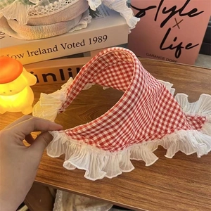 Detail of red and white checkered pet bandana with decorative white lace trim