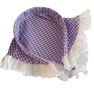 Detail of purple plaid triangular kerchief with white lace trim and small floral accent