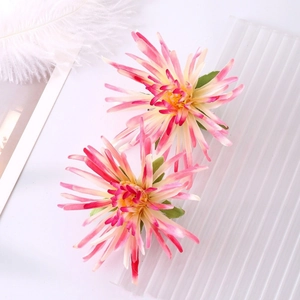 Elegant pair of pink and yellow gradient chrysanthemum flower hair clips with green leaves