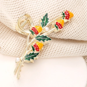 Elegant gold strawberry hair claw clip with red enamel and white pearl accents for women