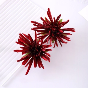 Detailed view of red crab claw chrysanthemum hair clips with velvet-like petal texture